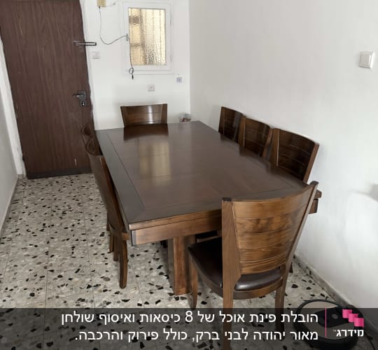 שואב אבק רובוטי ליד שולחן עץ וכיסאות